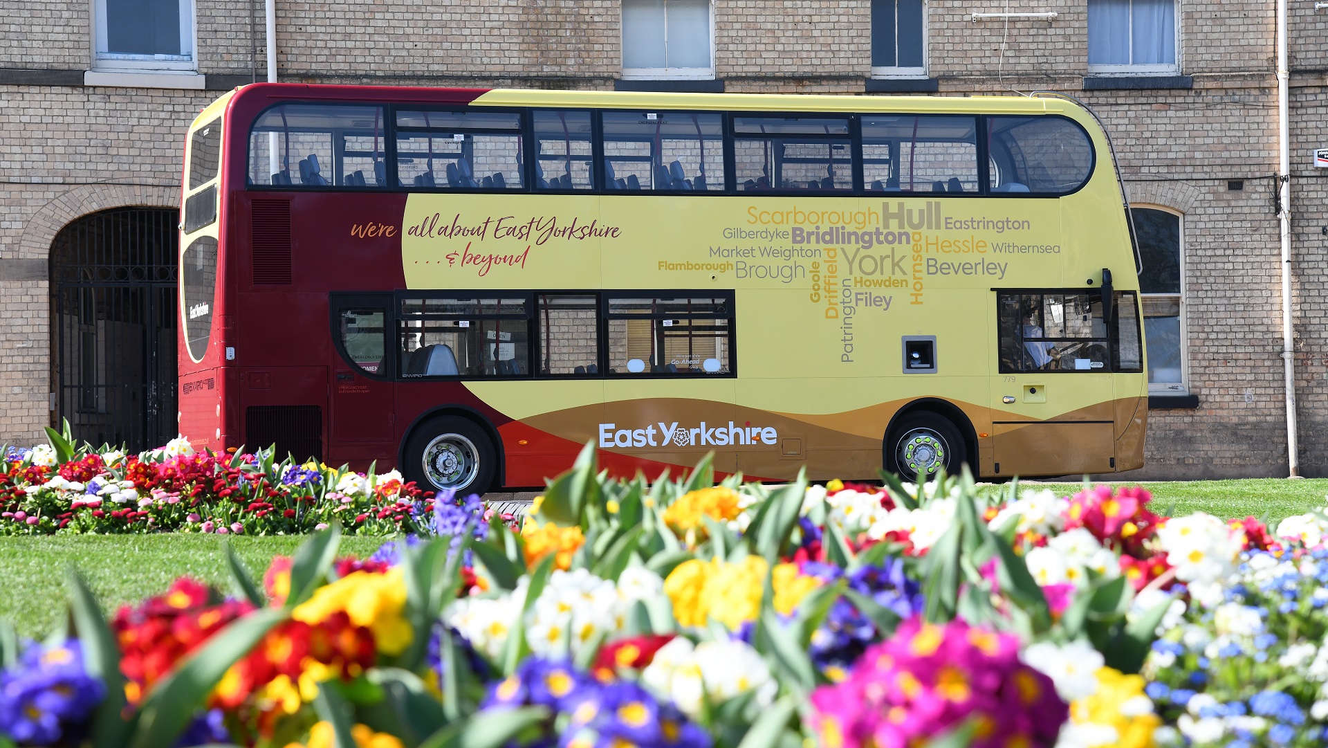 East Yorkshire double decker bus with spring flowers at the front.
