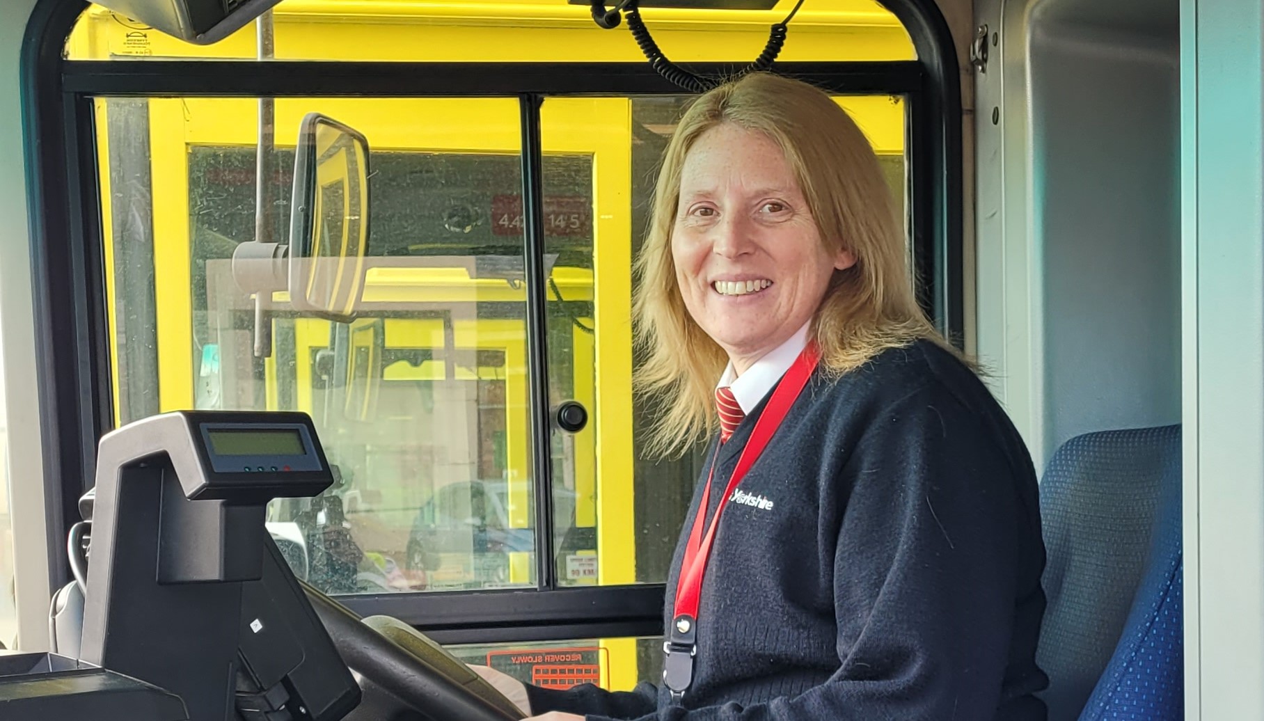 Photo of Donna, female bus driver, in an East Yorkshire Buses bus cab
